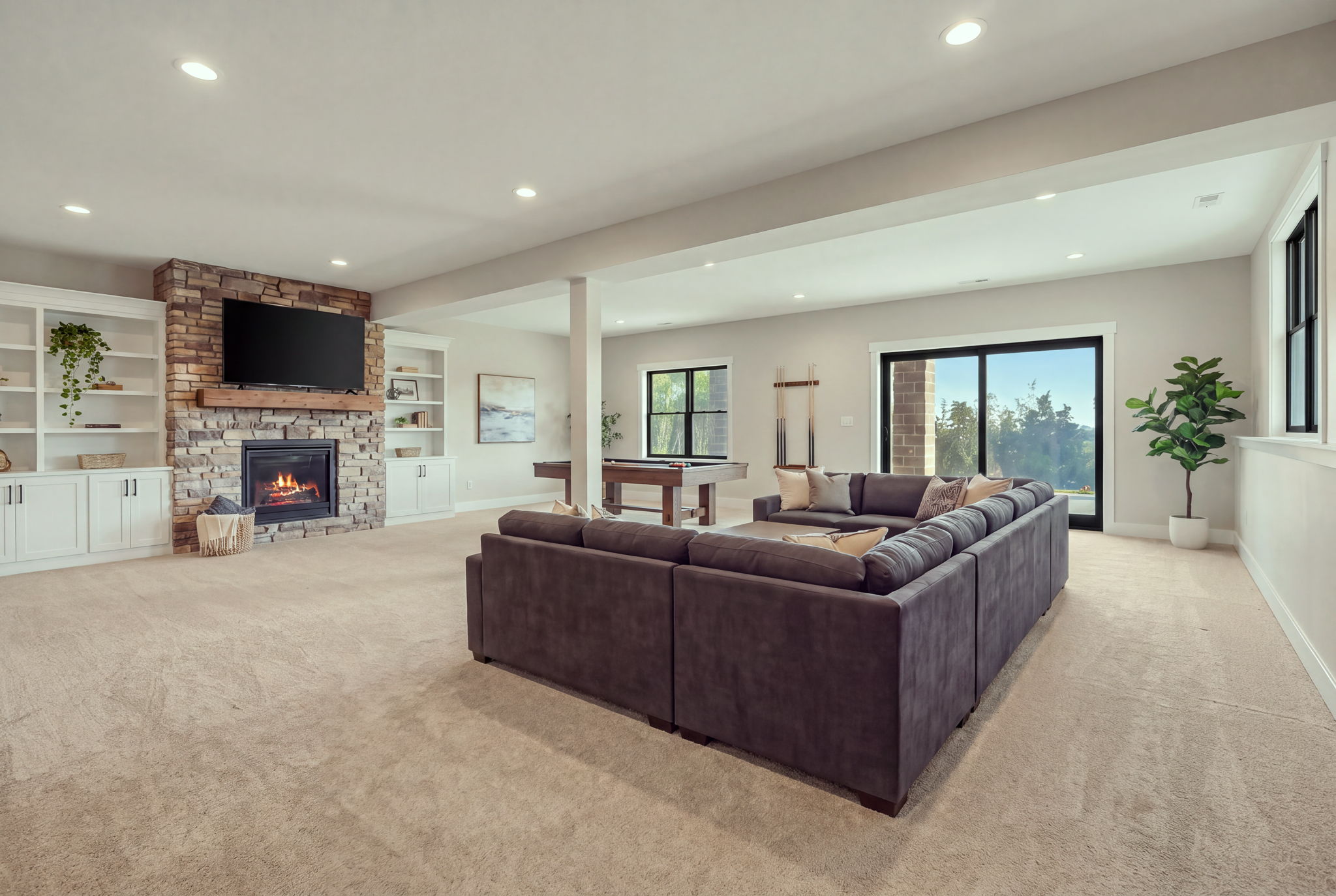 Lower-level living space with fireplace and pool table