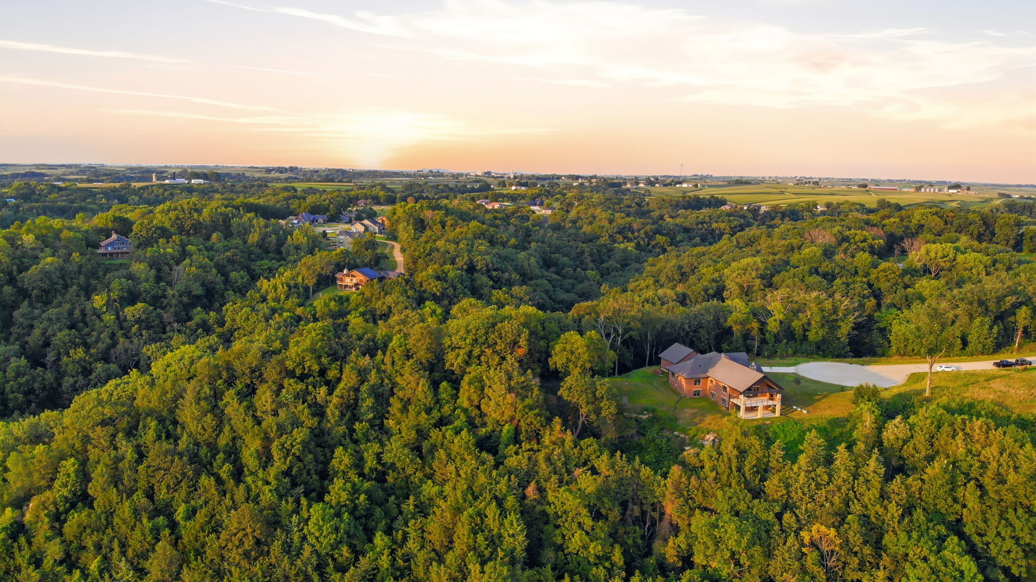 Aerial view of the house and wooded 2.51-acre lot
